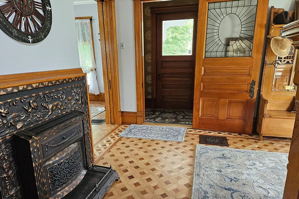 A room with wood floors and a fireplace.