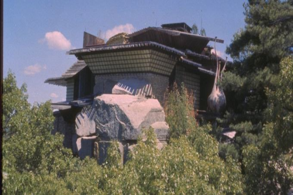 A house with a large roof and some trees