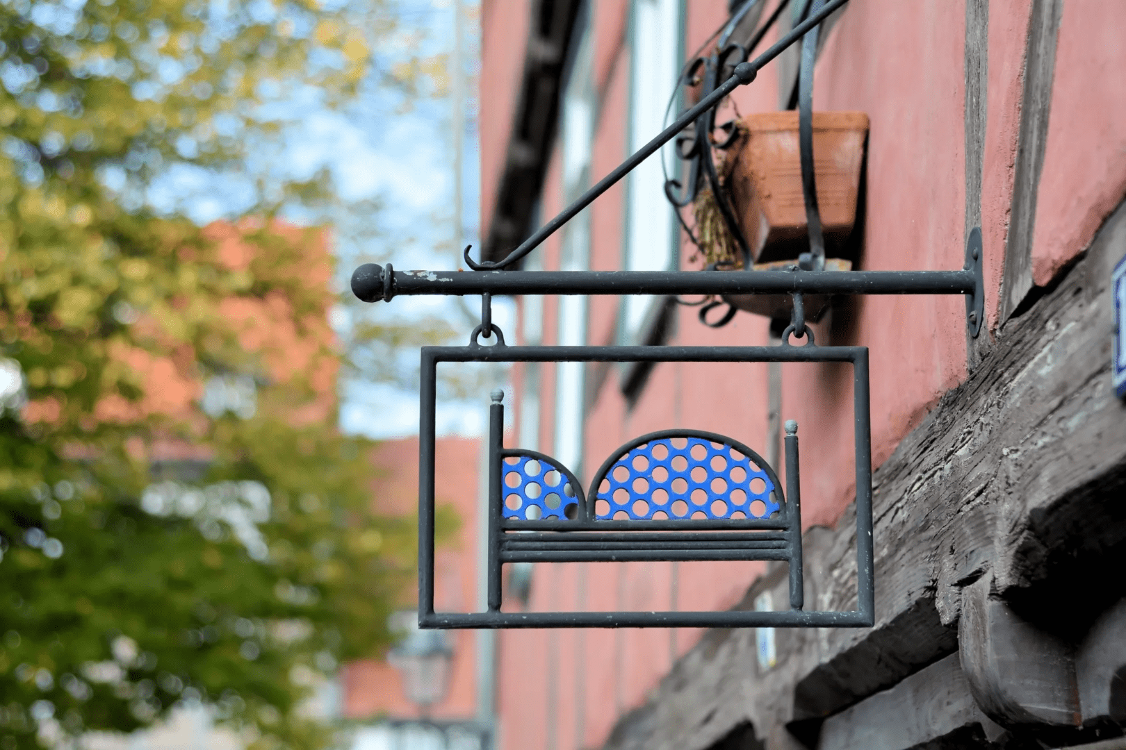 A sign hanging from the side of a building.