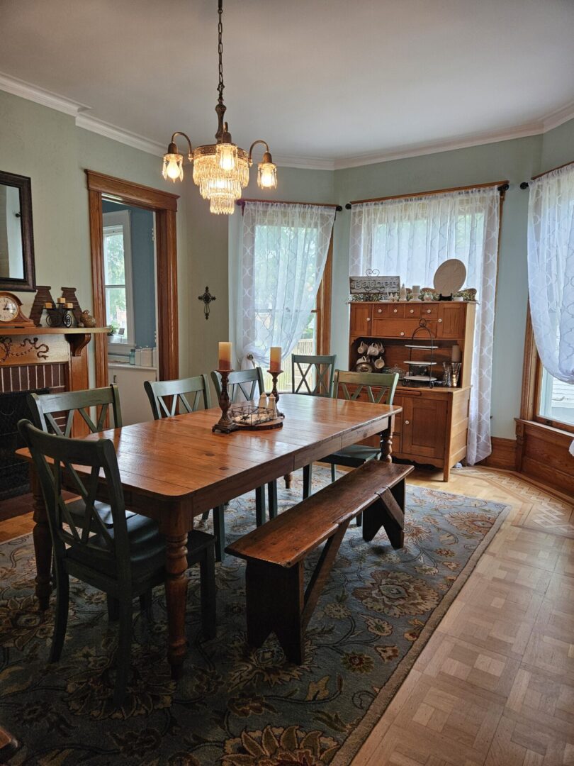 A dining room table with chairs and bench.