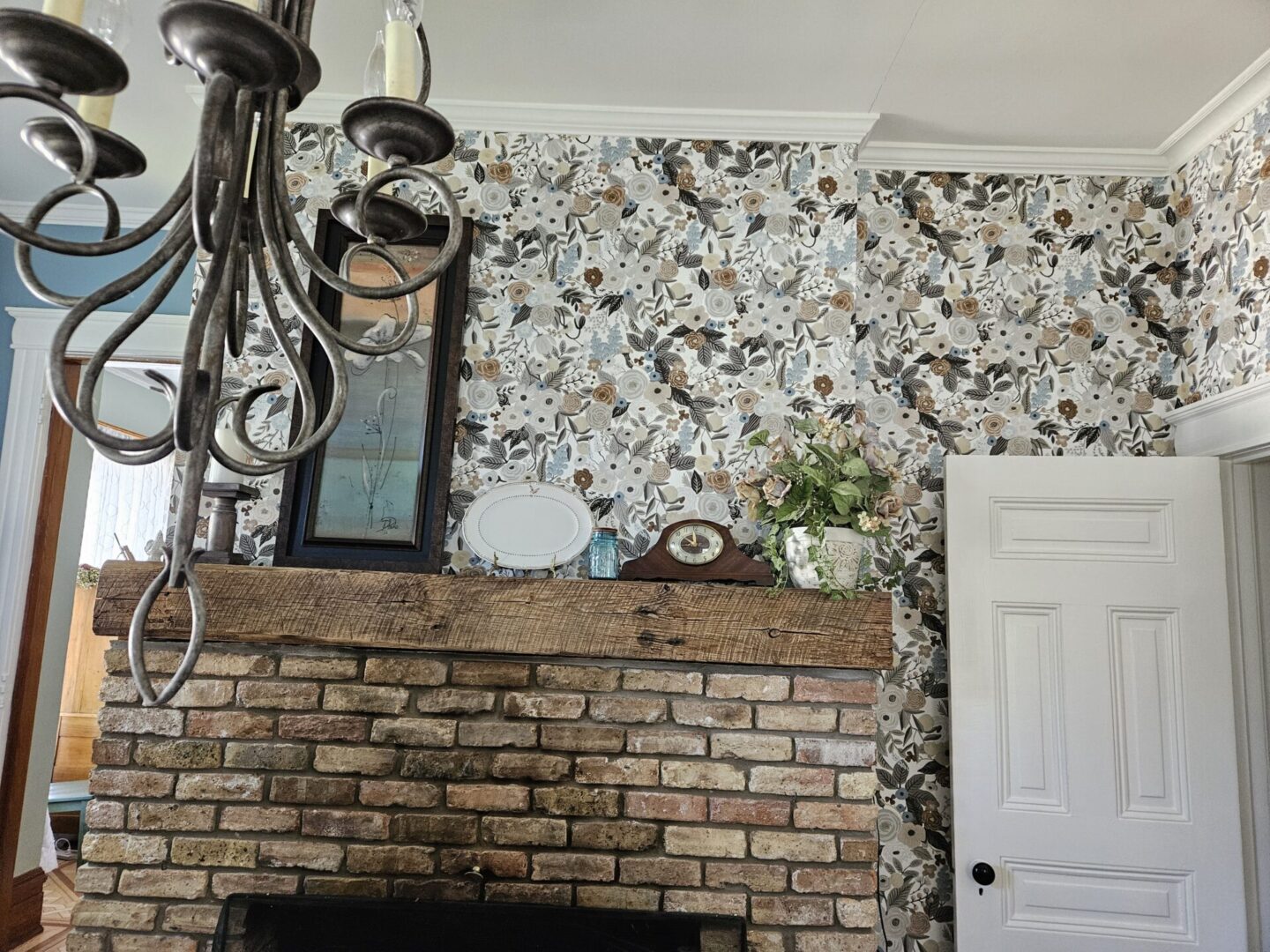 A fireplace with a clock above it and a mirror on the wall.