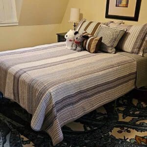 A bed with pillows and blankets on it