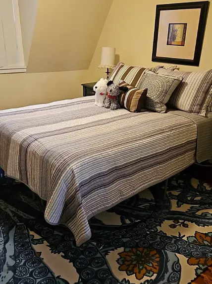 A bed with pillows and blankets on it