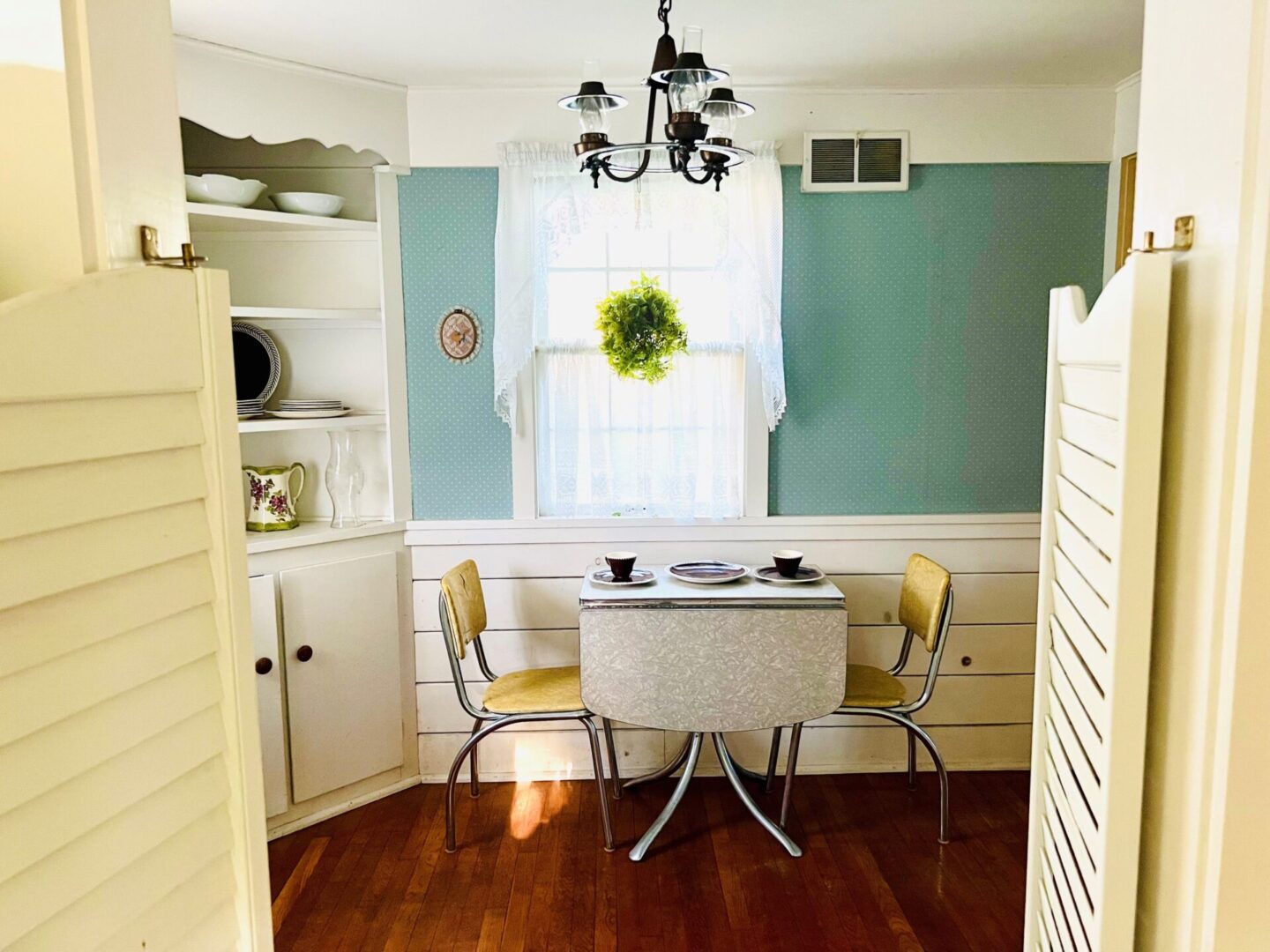 A dining room with two yellow chairs and a table